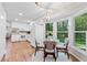 Eat-in kitchen features a modern chandelier, stainless appliances, and hardwood flooring at 3982 Battleford Ct, Atlanta, GA 30341