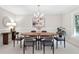 Dining room with a wood table, chandelier, and modern decor for inviting Gathering meals at 3982 Battleford Ct, Atlanta, GA 30341