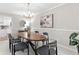 Dining room features stylish lighting, a wood table, and a view into the kitchen at 3982 Battleford Ct, Atlanta, GA 30341