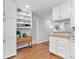 Clean white kitchen with ample cabinetry, granite countertops, and hardwood floors at 3982 Battleford Ct, Atlanta, GA 30341