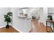 Spacious kitchen with breakfast bar that opens to a dining area, and gleaming hardwood floors at 3982 Battleford Ct, Atlanta, GA 30341