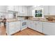 Bright kitchen with white cabinets, granite countertops, and stainless steel appliances at 3982 Battleford Ct, Atlanta, GA 30341
