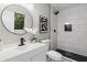 Modern bathroom featuring a sleek vanity, round mirror, and a glass-enclosed shower with white subway tile at 4983 Needle Knob Ct, Lithonia, GA 30038