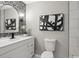 Chic half bathroom featuring new vanity, stylish finishes, and updated fixtures at 4983 Needle Knob Ct, Lithonia, GA 30038