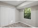 Bedroom featuring light grey paint, wood-look floors, closet space, and natural light at 4983 Needle Knob Ct, Lithonia, GA 30038