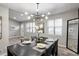 Bright dining room boasts a modern chandelier and a table with seating for four at 4983 Needle Knob Ct, Lithonia, GA 30038