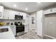 Modern kitchen with white cabinets, stainless steel appliances, and ample counter space at 4983 Needle Knob Ct, Lithonia, GA 30038