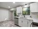 Kitchen boasts white cabinets, stainless steel appliances, and a view of the backyard at 4983 Needle Knob Ct, Lithonia, GA 30038