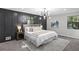 Large bedroom features modern lighting, paneling, soft, neutral tones, and many windows at 4983 Needle Knob Ct, Lithonia, GA 30038
