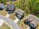 A high angle shows the home's backyard, landscaping, and neighborhood streets in an aerial view at 5780 Winding Lakes Dr, Cumming, GA 30028