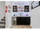 Stylish wet bar with mini fridge, granite countertop and custom shelving, perfect for entertaining at 5780 Winding Lakes Dr, Cumming, GA 30028