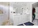 Bright bathroom with double vanity, tiled shower, and modern fixtures at 5780 Winding Lakes Dr, Cumming, GA 30028