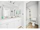 Bright bathroom with double vanity, neutral color palette, and shower-tub combination at 5780 Winding Lakes Dr, Cumming, GA 30028