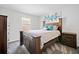 Cozy bedroom with natural light, a wood-frame bed, and stylish decor at 5780 Winding Lakes Dr, Cumming, GA 30028