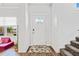 Bright entryway featuring a white door with glass panels and a stylish geometric rug at 5780 Winding Lakes Dr, Cumming, GA 30028