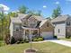 Charming two-story home with a well-manicured lawn, brick accents, and attached two-car garage at 5780 Winding Lakes Dr, Cumming, GA 30028