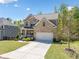 Attractive brick home with a well-manicured lawn, two-car garage, and inviting front porch at 5780 Winding Lakes Dr, Cumming, GA 30028