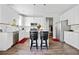 Modern kitchen with white cabinets, stainless steel appliances, and a stylish breakfast bar at 5780 Winding Lakes Dr, Cumming, GA 30028