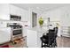 Bright kitchen featuring stainless appliances, white cabinetry, and granite countertops at 5780 Winding Lakes Dr, Cumming, GA 30028