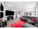 Spacious living room with gray sofa, entertainment center and decor at 5780 Winding Lakes Dr, Cumming, GA 30028