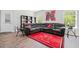 Cozy living room with gray sectional, wood flooring and a bright red area rug at 5780 Winding Lakes Dr, Cumming, GA 30028