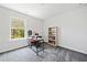 Well-lit office with a large window, functional desk, and a built-in bookshelf at 5780 Winding Lakes Dr, Cumming, GA 30028