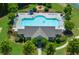 Aerial shot of a community pool featuring plentiful seating, a clear blue pool, and a cozy building at 5780 Winding Lakes Dr, Cumming, GA 30028