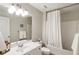 Bathroom featuring white cabinets, a white shower curtain, and a large mirror reflecting the bright space at 2238 Parkview Nw Ct, Atlanta, GA 30318
