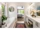 Bright bathroom featuring a soaking tub, double vanity, and a seamless transition into the bedroom at 2238 Parkview Nw Ct, Atlanta, GA 30318