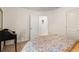 Bedroom with neutral walls, a bed with a colorful patterned blanket, and an adjacent room visible through an open door at 2238 Parkview Nw Ct, Atlanta, GA 30318