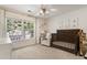 Charming Bedroom with a dark wood crib, cozy chair, and a large window providing ample natural light at 2238 Parkview Nw Ct, Atlanta, GA 30318