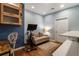 Versatile bonus room featuring blue walls, a comfortable sofa, and a functional workout station at 2238 Parkview Nw Ct, Atlanta, GA 30318