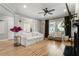 Open-concept living room with hardwood floors, a white sofa, and large windows at 2238 Parkview Nw Ct, Atlanta, GA 30318