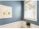 Powder room with beadboard wainscoting, a window and a framed art print at 2238 Parkview Nw Ct, Atlanta, GA 30318