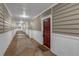 Hallway view of condo with neutral decor and a red front door at 2700 Pine Tree Ne Rd # 1015, Atlanta, GA 30324