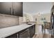 Modern kitchen featuring sleek black cabinetry, stainless steel appliances, and beautiful backsplash at 2700 Pine Tree Ne Rd # 1015, Atlanta, GA 30324