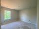 Bedroom with a large window offering views of trees and an electrical box on the wall at 4556 Sweetlake Sw Ct, Mableton, GA 30126