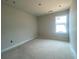 Bright bedroom with a large window showing exterior view and electrical box on the wall at 4556 Sweetlake Sw Ct, Mableton, GA 30126
