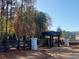 Sweetlake Grove community entrance featuring a pergola, black fence, and manicured landscaping at 4556 Sweetlake Sw Ct, Mableton, GA 30126