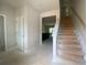 Entry way showing stairs and door leading to a spacious kitchen at 4556 Sweetlake Sw Ct, Mableton, GA 30126