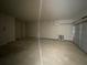 A large garage with concrete floors and overhead lighting providing plenty of space at 4556 Sweetlake Sw Ct, Mableton, GA 30126