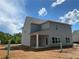 Back of home with covered porch, gray siding and a view of the yard at 4556 Sweetlake Sw Ct, Mableton, GA 30126