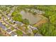 Aerial view of homes nestled within a picturesque community surrounding a tranquil pond and lush green landscape at 17 Brightwater Cv, Dallas, GA 30157