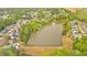 An aerial view displays homes situated within a serene community encircling a peaceful pond and verdant landscape at 17 Brightwater Cv, Dallas, GA 30157
