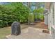 Backyard area with a grill, patio, and play area, perfect for outdoor activities at 17 Brightwater Cv, Dallas, GA 30157