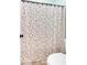 Cozy bathroom featuring a polka-dot shower curtain and standard toilet at 17 Brightwater Cv, Dallas, GA 30157