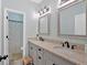 This shared bathroom features a double sink vanity and a shower/tub combination with fun, colorful shower curtain at 17 Brightwater Cv, Dallas, GA 30157