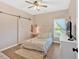 Bedroom with wood-look floors, a sliding barn door, and soft natural light offers cozy charm at 17 Brightwater Cv, Dallas, GA 30157