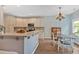 This eat-in kitchen boasts a breakfast bar, stylish chandelier, and an open layout, perfect for gatherings at 17 Brightwater Cv, Dallas, GA 30157