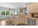 Bright eat-in kitchen features wood floors, stainless appliances and an open pass-through to the living area at 17 Brightwater Cv, Dallas, GA 30157